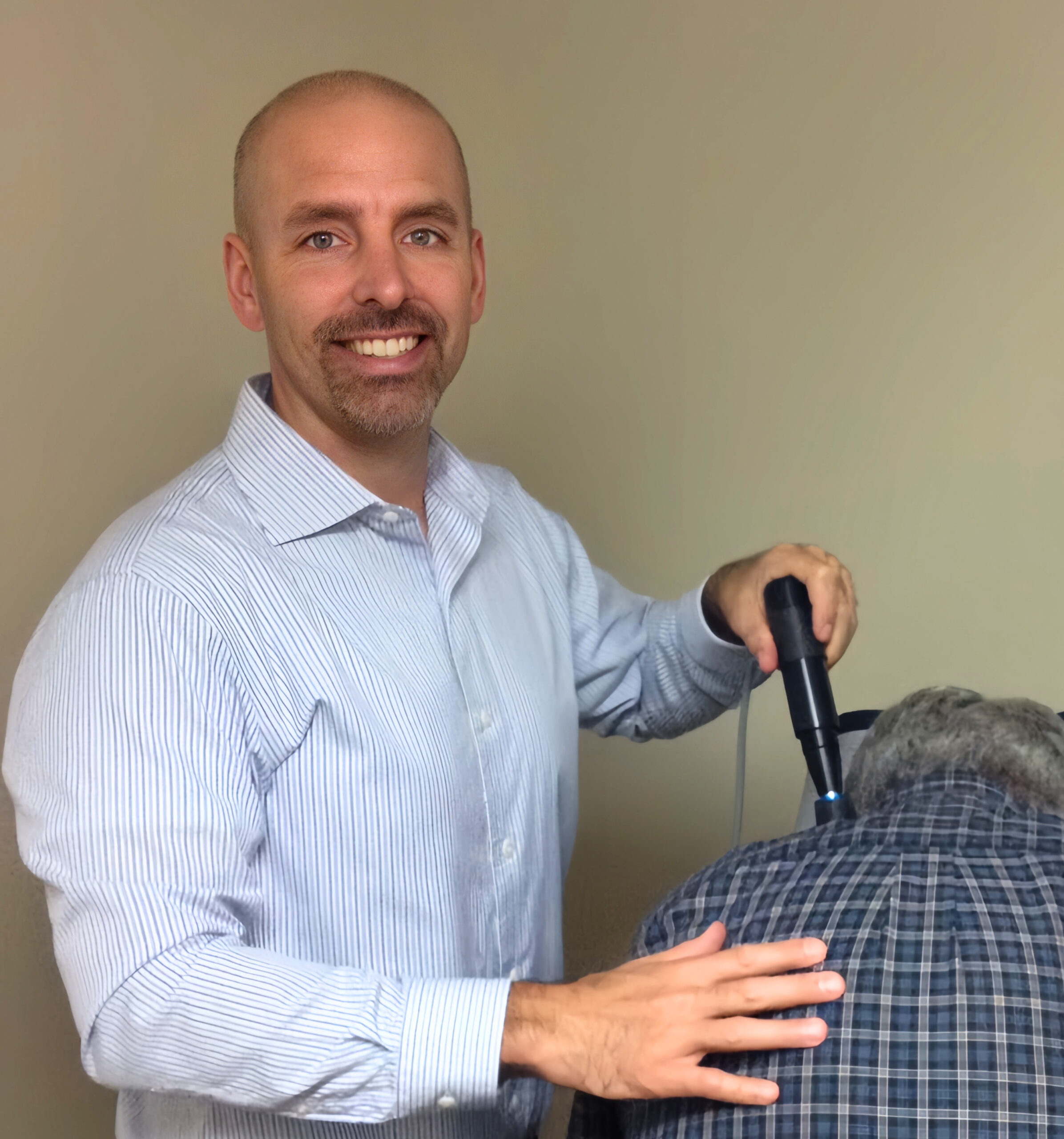Dr. Kamego performing a chiropractic adjustment on a patient at Kamego Chiropractic in Almont Michigan serving Lapeer County